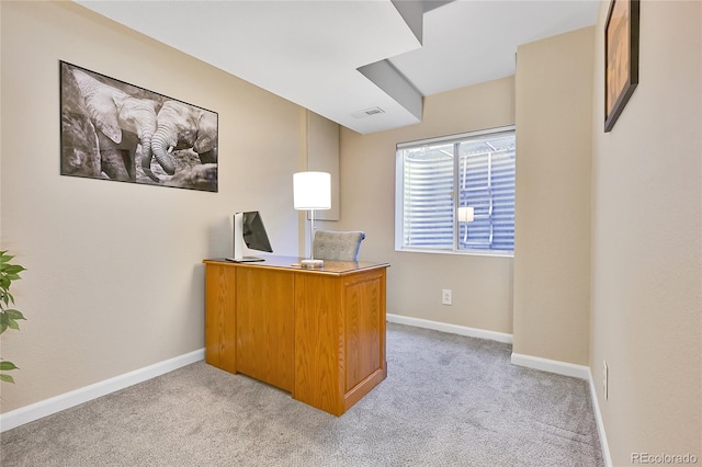 office space with visible vents, light colored carpet, and baseboards