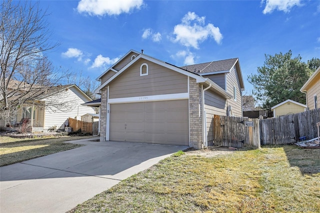 exterior space featuring an attached garage, driveway, a front lawn, and fence