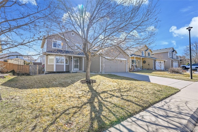 view of front of property featuring fence, a residential view, concrete driveway, a front yard, and an attached garage