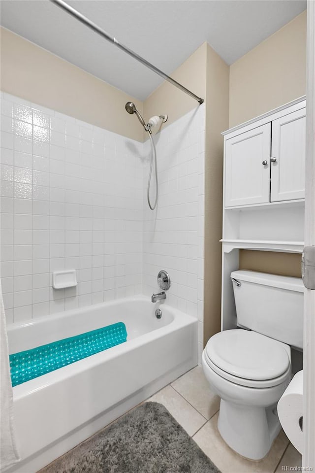 bathroom featuring tile patterned floors, toilet, and shower / bathing tub combination