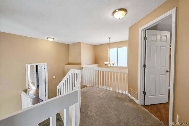 corridor featuring an upstairs landing, baseboards, and carpet floors