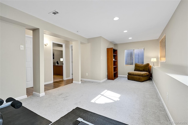 living area with visible vents, recessed lighting, baseboards, and carpet floors