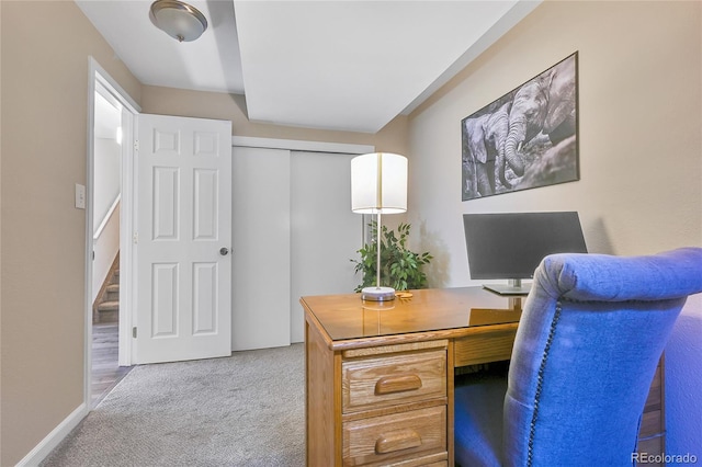 carpeted office featuring baseboards