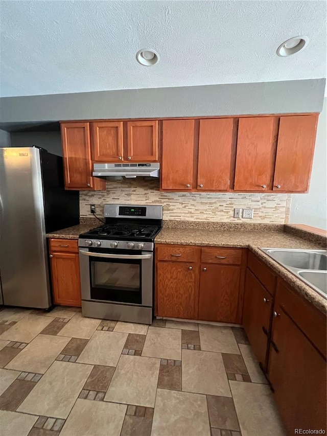 kitchen with decorative backsplash, stainless steel appliances, and sink