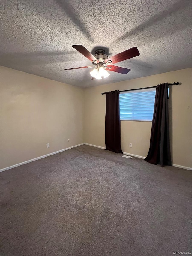 carpeted spare room featuring ceiling fan and a textured ceiling