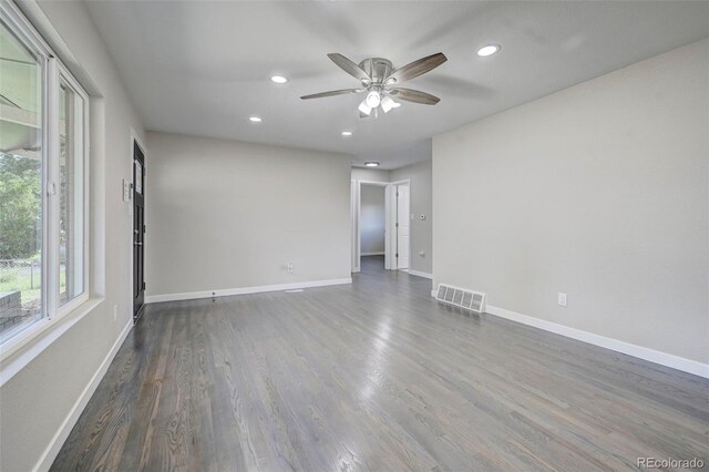 spare room featuring dark wood-type flooring and ceiling fan