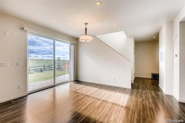 spare room featuring dark hardwood / wood-style flooring