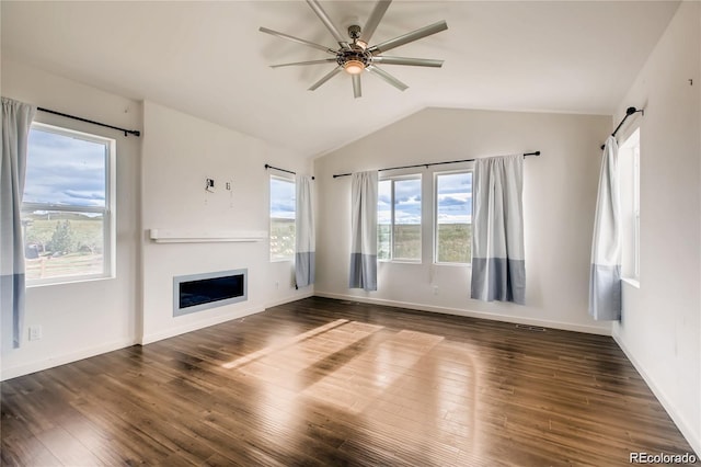 unfurnished living room featuring ceiling fan, dark wood-type flooring, lofted ceiling, and a barn door