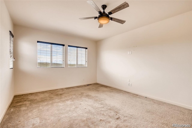 empty room with ceiling fan and carpet flooring