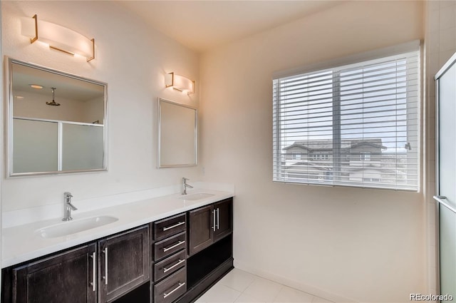 bathroom featuring an enclosed shower, vanity, and tile patterned flooring