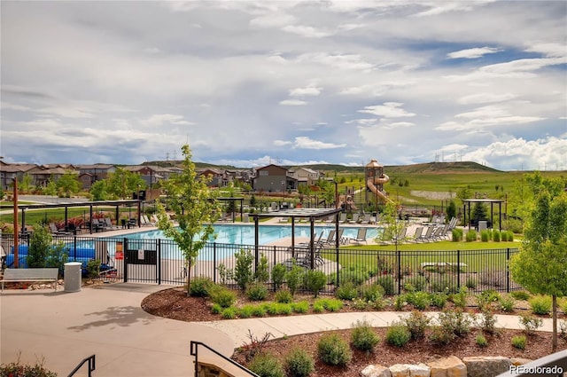 view of pool featuring a patio area and a playground