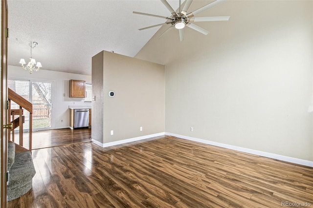 unfurnished living room with a textured ceiling, ceiling fan with notable chandelier, dark hardwood / wood-style floors, and vaulted ceiling