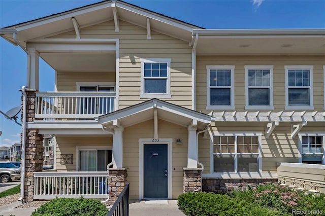 9387 Ashbury Cir Unit 203, Parker, CO 80134 - multi unit property with a balcony, covered porch, and stone siding