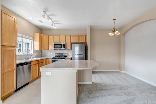 9387 Ashbury Cir Unit 203, Parker, CO 80134 - kitchen featuring appliances with stainless steel finishes, light countertops, light brown cabinets, backsplash, and a kitchen island