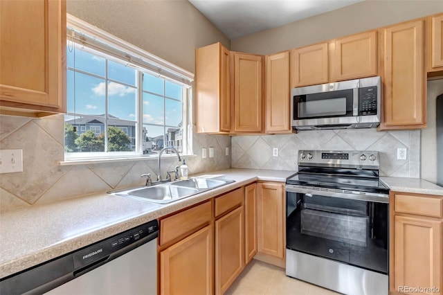 9387 Ashbury Cir Unit 203, Parker, CO 80134 - kitchen featuring stainless steel appliances, light brown cabinets, light countertops, backsplash, and light tile patterned flooring