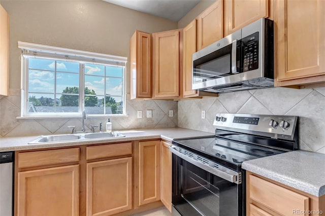 9387 Ashbury Cir Unit 203, Parker, CO 80134 - kitchen with appliances with stainless steel finishes, light brown cabinetry, backsplash, and light countertops