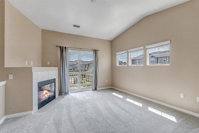 9387 Ashbury Cir Unit 203, Parker, CO 80134 - unfurnished living room featuring carpet flooring, lofted ceiling, and a fireplace