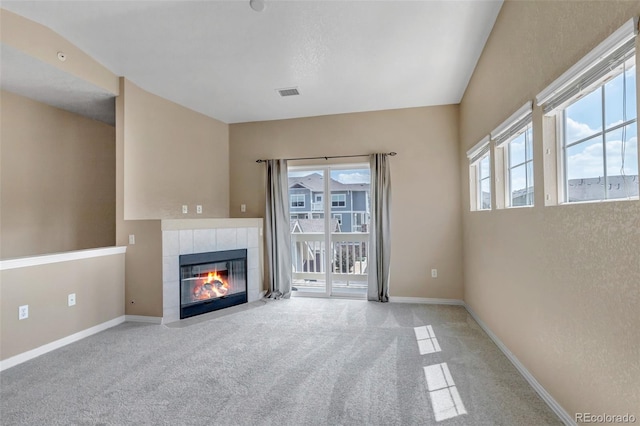 9387 Ashbury Cir Unit 203, Parker, CO 80134 - unfurnished living room featuring carpet flooring and a tile fireplace