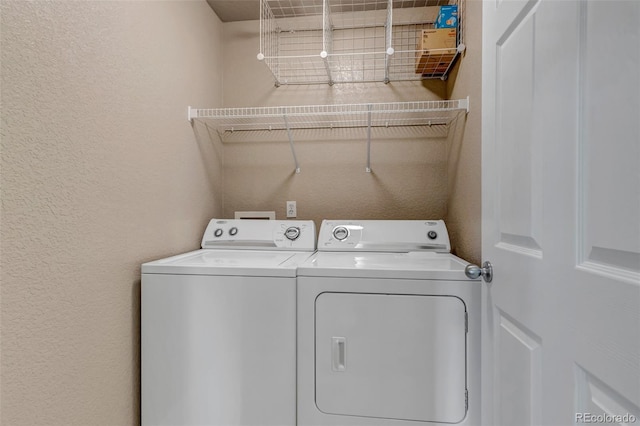 9387 Ashbury Cir Unit 203, Parker, CO 80134 - washroom featuring washing machine and dryer and a textured wall