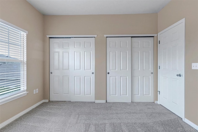 9387 Ashbury Cir Unit 203, Parker, CO 80134 - unfurnished bedroom with two closets and carpet flooring
