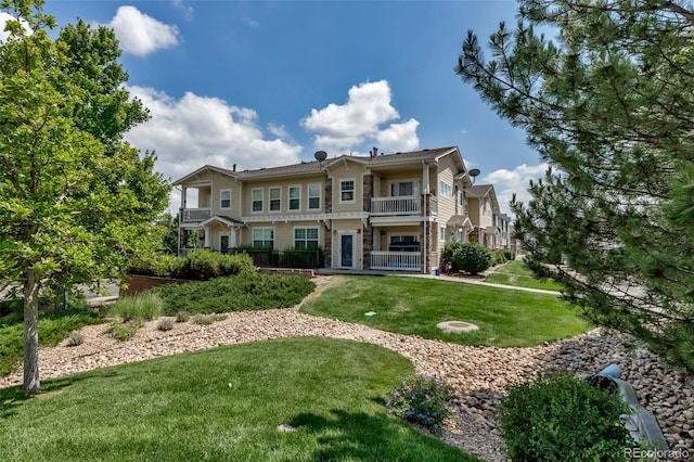 9387 Ashbury Cir Unit 203, Parker, CO 80134 - view of front of home featuring a balcony and a front lawn