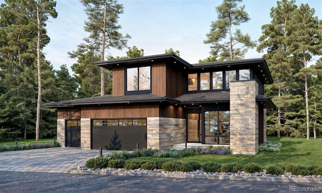 view of front of property featuring a garage and a front yard