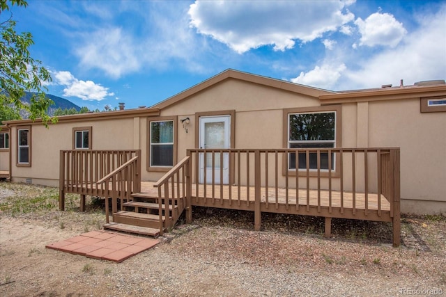 110 Evans Ave, Poncha Springs, CO 81242 - rear view of property featuring a wooden deck and stucco siding