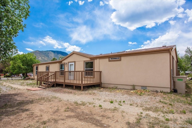 110 Evans Ave, Poncha Springs, CO 81242 - rear view of house with a deck with mountain view, crawl space, and stucco siding