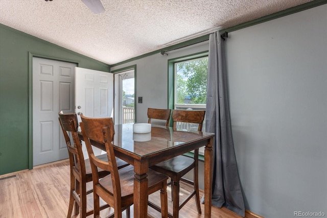 110 Evans Ave, Poncha Springs, CO 81242 - dining space with a textured ceiling, vaulted ceiling, light wood finished floors, and crown molding