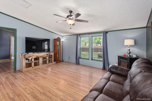 110 Evans Ave, Poncha Springs, CO 81242 - living area with a textured ceiling, light wood-style flooring, a ceiling fan, a wood stove, and crown molding