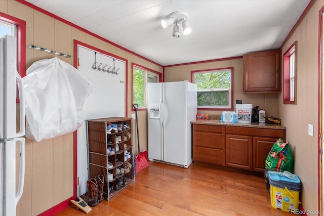 110 Evans Ave, Poncha Springs, CO 81242 - kitchen with white fridge with ice dispenser, freestanding refrigerator, light wood-style flooring, brown cabinets, and crown molding