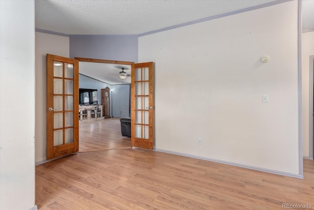 110 Evans Ave, Poncha Springs, CO 81242 - spare room with french doors, light wood-type flooring, a textured ceiling, crown molding, and a ceiling fan
