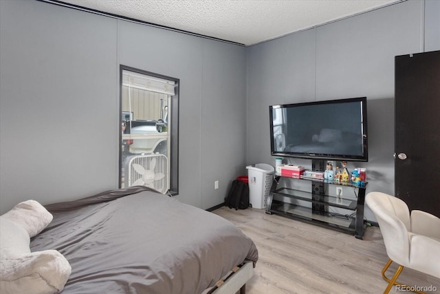 110 Evans Ave, Poncha Springs, CO 81242 - bedroom featuring wood finished floors and a textured ceiling