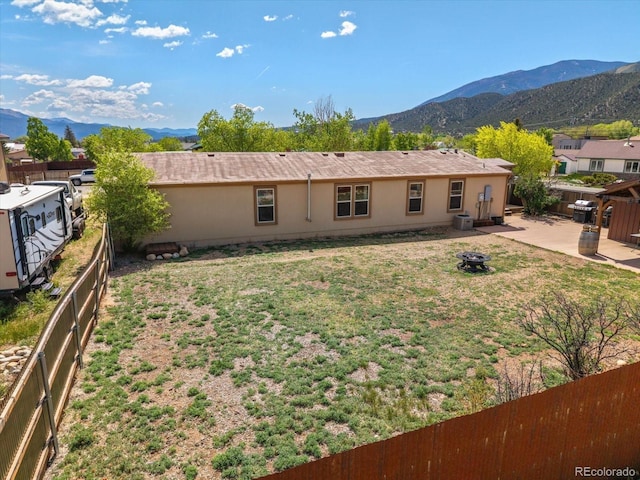 110 Evans Ave, Poncha Springs, CO 81242 - view of front of property featuring a mountain view, an outdoor fire pit, and a fenced backyard