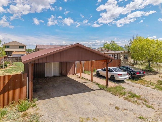 110 Evans Ave, Poncha Springs, CO 81242 - view of front facade featuring board and batten siding, a detached carport, and driveway