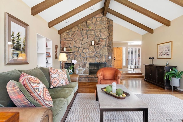 1555 Genesee Ridge Rd, Golden, CO 80401 - living area featuring wood finished floors, beamed ceiling, a fireplace, and high vaulted ceiling