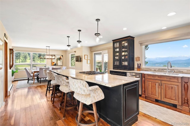 1555 Genesee Ridge Rd, Golden, CO 80401 - kitchen with appliances with stainless steel finishes, light stone countertops, a kitchen breakfast bar, a kitchen island, and glass insert cabinets