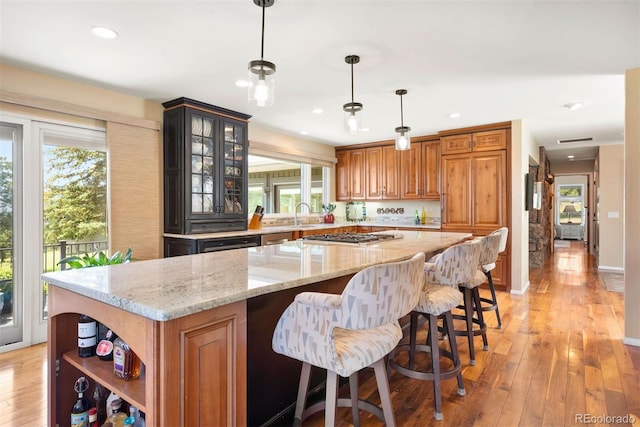 1555 Genesee Ridge Rd, Golden, CO 80401 - kitchen with brown cabinetry, a kitchen island, healthy amount of natural light, light wood-style floors, and recessed lighting