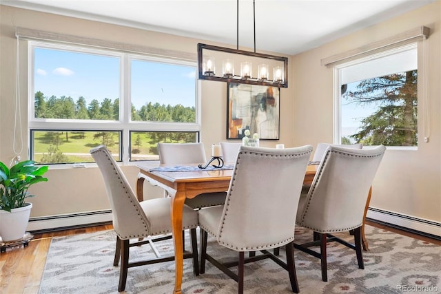1555 Genesee Ridge Rd, Golden, CO 80401 - dining area with wood finished floors and a baseboard radiator