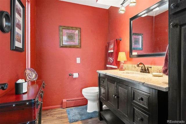 1555 Genesee Ridge Rd, Golden, CO 80401 - half bathroom with a baseboard radiator, wood finished floors, and vanity