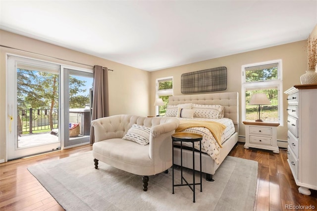 1555 Genesee Ridge Rd, Golden, CO 80401 - bedroom with access to outside, dark wood finished floors, and a baseboard radiator