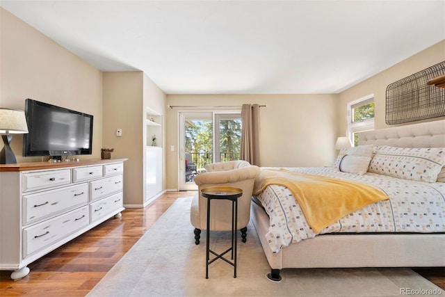 1555 Genesee Ridge Rd, Golden, CO 80401 - bedroom featuring wood finished floors and access to outside