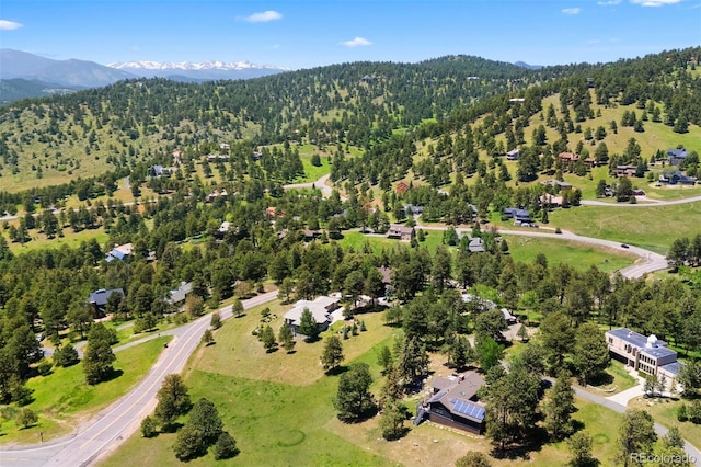 1555 Genesee Ridge Rd, Golden, CO 80401 - aerial overview of property's location with a mountainous background and a forest