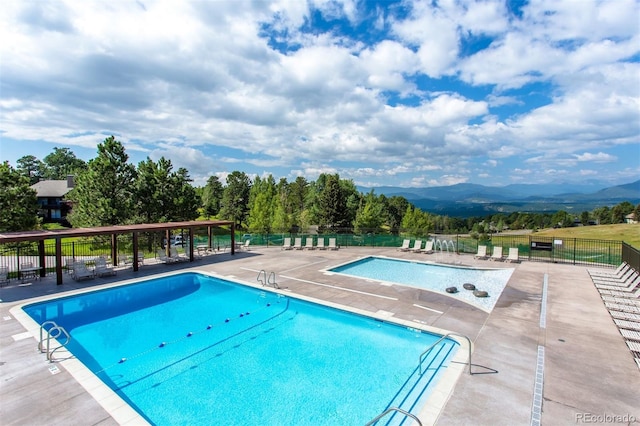 1555 Genesee Ridge Rd, Golden, CO 80401 - community pool featuring a mountain view and a patio