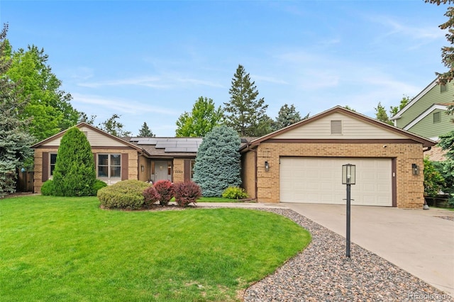 9939 E Aberdeen Ave, Englewood, CO 80111 - ranch-style home with brick siding, a front yard, driveway, and solar panels