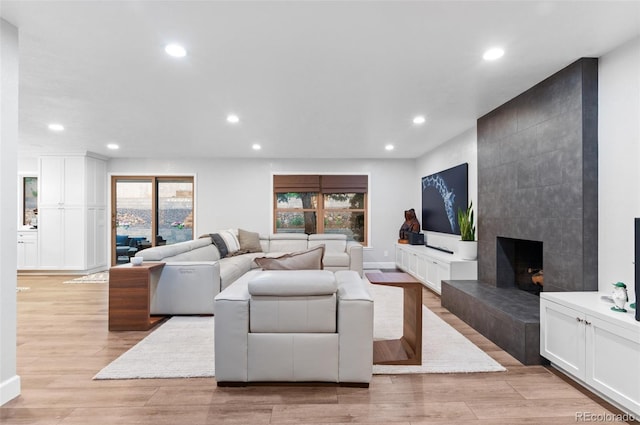 9939 E Aberdeen Ave, Englewood, CO 80111 - living room featuring healthy amount of natural light, recessed lighting, light wood-style floors, and a fireplace