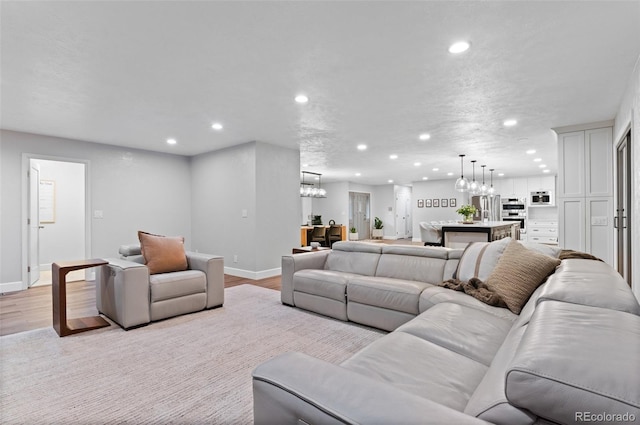 9939 E Aberdeen Ave, Englewood, CO 80111 - living room featuring a chandelier, recessed lighting, light wood-style floors, and baseboards