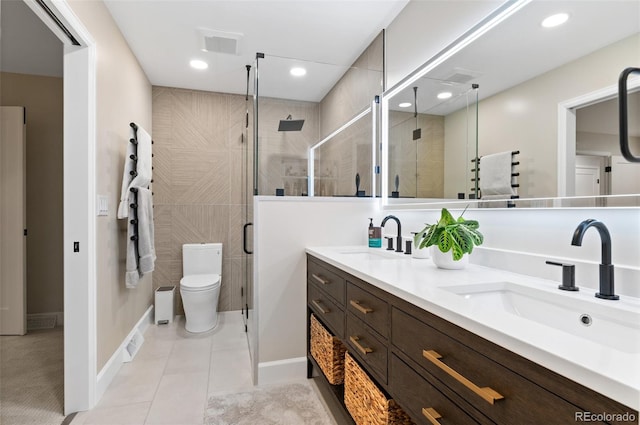 9939 E Aberdeen Ave, Englewood, CO 80111 - bathroom featuring double vanity, a shower stall, toilet, tile patterned flooring, and recessed lighting