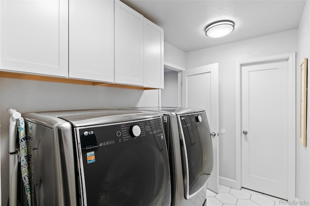 9939 E Aberdeen Ave, Englewood, CO 80111 - laundry area featuring cabinet space, washer and dryer, and light tile patterned floors