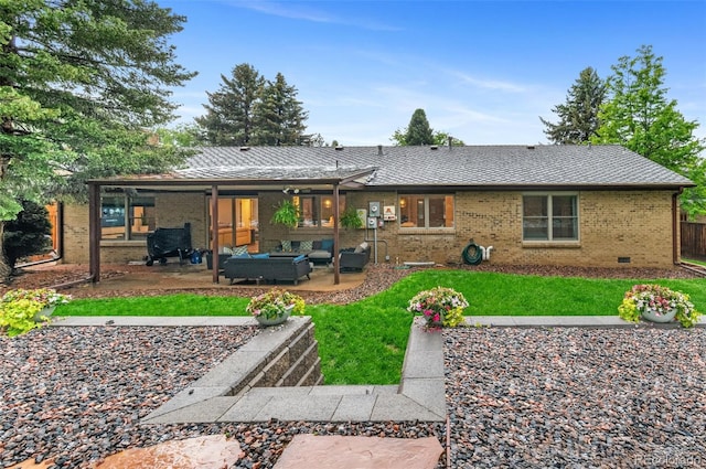 9939 E Aberdeen Ave, Englewood, CO 80111 - back of property with an outdoor hangout area, a patio, brick siding, and a lawn